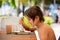 Sweet preschool boy, eating desert in a restaurant on beach summer resort