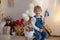 Sweet preschool boy in studio, playing with, egg for Easter and eating chocolate, child on Easter holiday