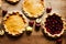 Sweet pumpkin pie on wooden table with fruits and berries