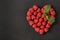 Sweet raspberry heart on dark stone board