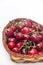 SWEET RED CHERRIES WOODEN BASKET WHITE BACKGROUND