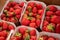 Sweet ripe french red strawberries in paper boxes on Provencal farmers market, Cassis, France