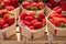 Sweet ripe french red strawberries in wooden boxes on Provencal farmers market, Cassis, France