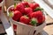 Sweet ripe french red strawberries in wooden boxes on Provencal farmers market, Cassis, France