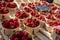 Sweet ripe french red strawberries in wooden boxes on Provencal farmers market, Cassis, France. English translation Strawberry