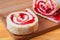 Sweet roll with jam on a cutting board.