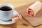 Sweet roll with jam on a cutting board. Cup of tea on a wooden table.