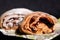 Sweet roll sprinkled with powder on a napkin. Shallow depth of field