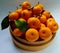 sweet santang orange fruit served in a bamboo bowl on a white background