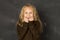 Sweet schoolgirl in uniform laughing excited in front of school class blackboard smiling happy