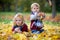 Sweet siblings, brother and sister, playing in the park with lea