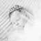 Sweet sleeping newborn baby girl with crown jewelry sleeping ona grey blanket