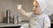 A sweet small chef cook in a white culinary cap mixes the flour with a metal spoon.