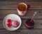 A sweet snack with cranberry marshmallows and marmalade, tea in a large ceramic mug and a glass jar with cherry jam and