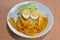 Sweet and sour egg with spicy yellow curry bamboo shoot on rice