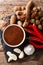 Sweet and sour spicy tamarind sauce with ingredients close-up on a table. Vertical top view