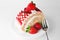 Sweet strawberry cake on white plate with fork