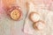 Sweet sugary donuts and vintage clock on rustic table