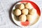 Sweet suji laddu in a plate on white isolated background