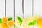 Sweet summer lemonade, top view border on a white wood background