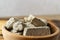 Sweet sunflower halva in a wooden bowl on a wooden table in the kitchen. Rustic style. Traditional natural sweets.