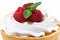 sweet tartlet with meringue and fresh raspberry on white table