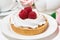 Sweet tartlet with meringue and raspberry, closeup