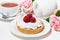sweet tartlet with meringue and raspberry, cup of tea