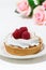 Sweet tartlet with meringue and raspberry, vertical
