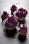 Sweet and tasty cupcakes with violet whipped cream