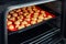 Sweet tasty delicious curd ginger cookies baking in hot oven stove on tray and red bright silicone bakery mat at home