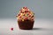 Sweet tasty vanilla cupcake whipped cream sprinkles topping pastry with wrapped festive Birthday present gift box orange