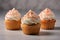 Sweet tasty vanilla cupcake whipped cream sprinkles topping pastry with wrapped festive Birthday present gift box orange