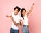 Sweet teen couple dancing and fooling, pink background