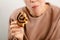 Sweet temptation: An attractive woman enjoys a raisin bun, succumbing to the sweet temptation of her delectable dessert
