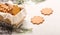 Sweet thin ginger cookies in a gift box on white background on a plaid. Festive pastry, cozy home.