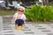 Sweet toddler boy, sitting on potty on a back porch in a holiday resort patio