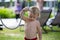 Sweet toddler boy, taking a shower on outdoor showers on the beach