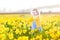 Sweet toddler girl field of yellow daffodil flowers