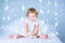 Sweet toddler girl playing with her toy bear in a white bedroom between