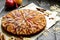 Sweet traditional homemade german apple pie cake with nuts and cinnamon on dark wooden table