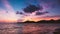 Sweet twilight sky and silhouetted mountain at sea