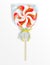 Sweet twisted candy lollipop with Halloween striped pattern on wooden stick packed in a transparent gift bag with ribbon