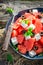 Sweet watermelon salad with feta, olives and mint leaves