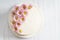 Sweet white buttercream cake with pink flowers on top