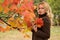 Sweet woman dreams under an autumn tree