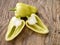 Sweet yellow bulgarian pepper, cut. Isolated on wooden table