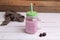 Sweet and yummy blackberry smoothie in the glass jar with a straw