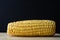 Sweetcorn Cob on Wooden Chopping Board against Black