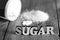 Sweetener tablet and sugar. Text sugar wooden letters.